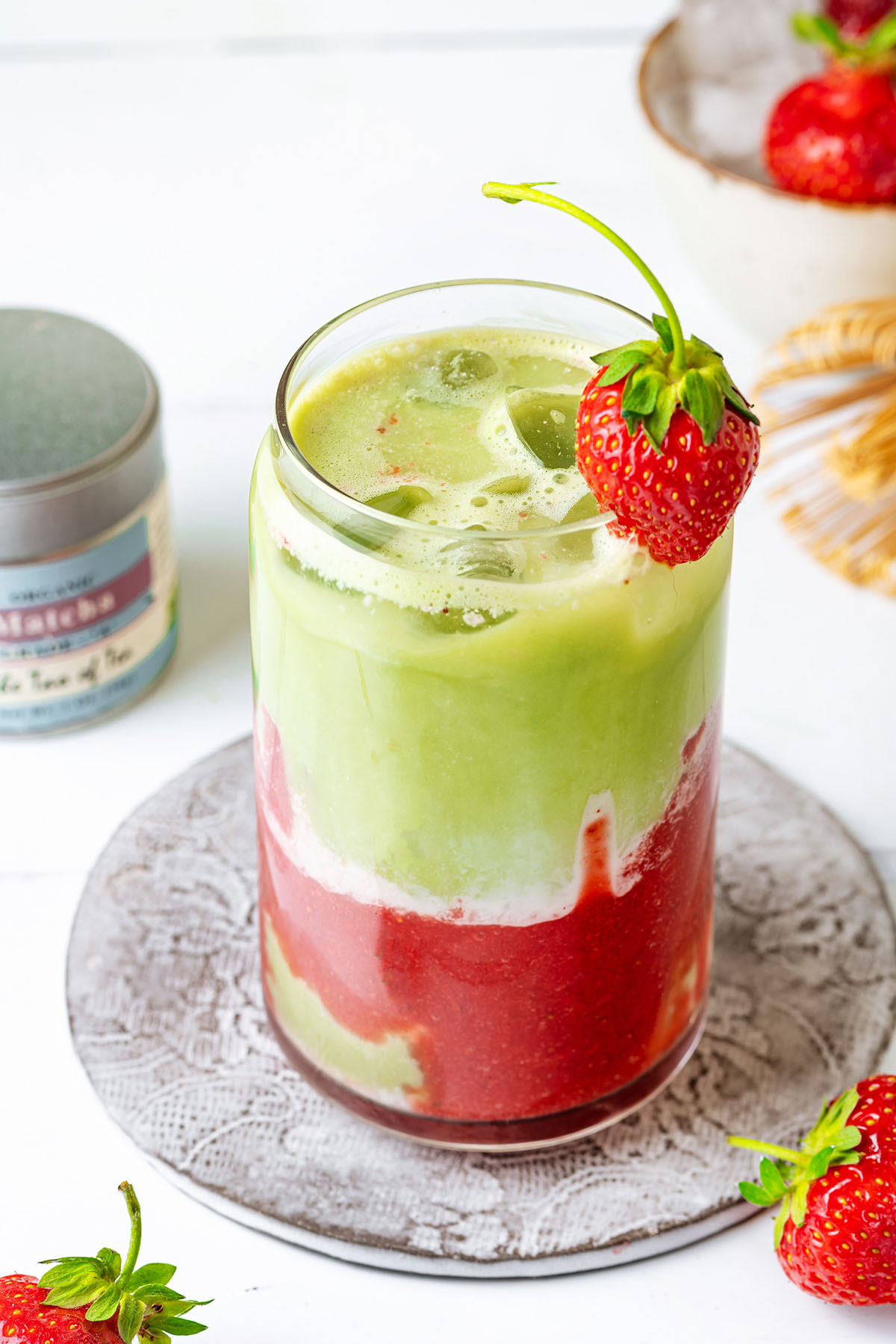Iced matcha latte with layers of strawberry purree, milk