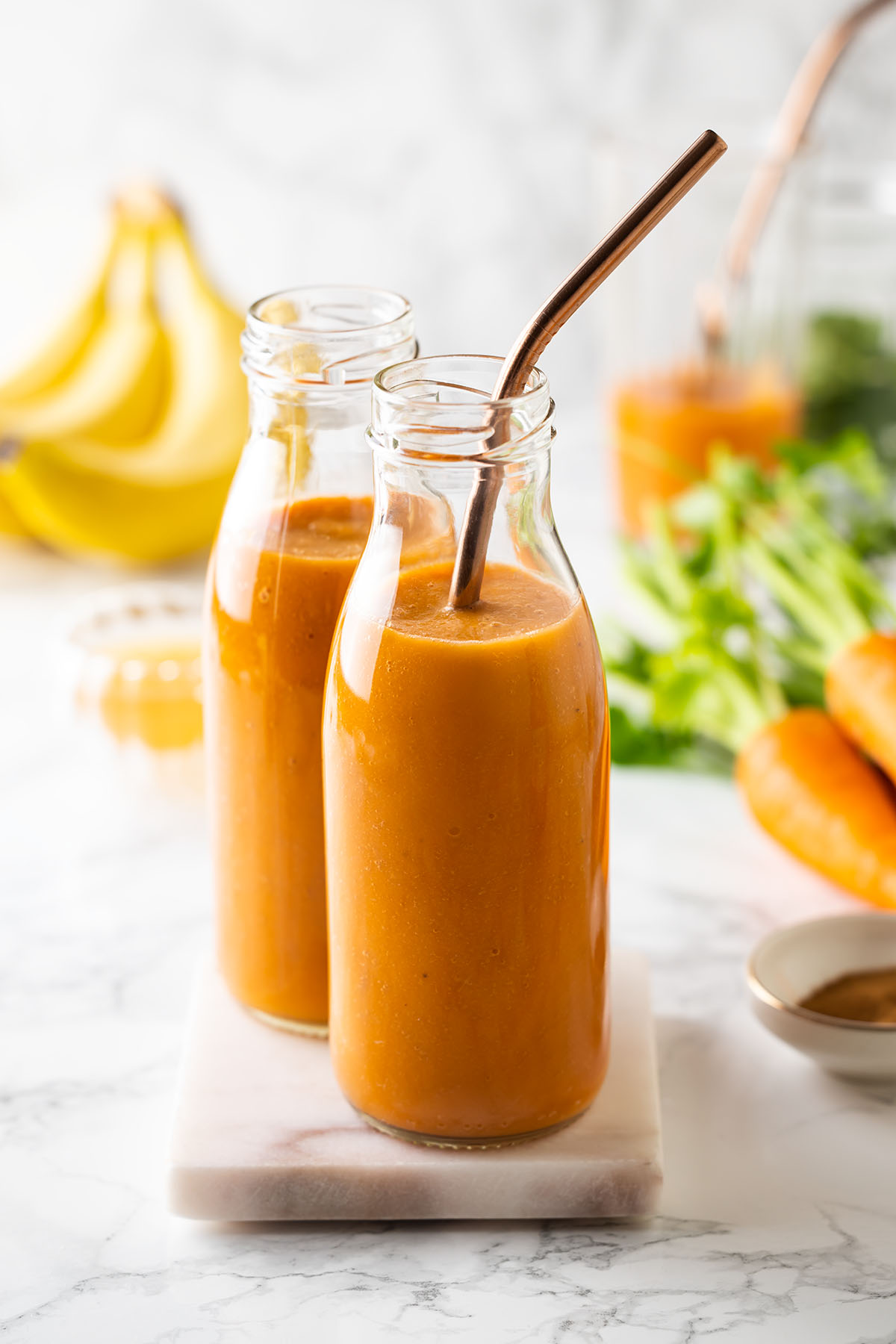 Carrot and Banana Smoothie in two glass bottles