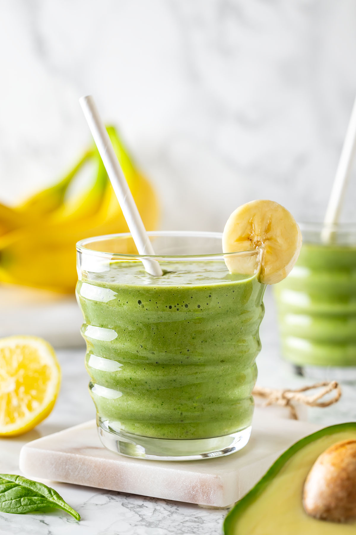Avocado banana peanut butter smoothie decorated with a slice of banana