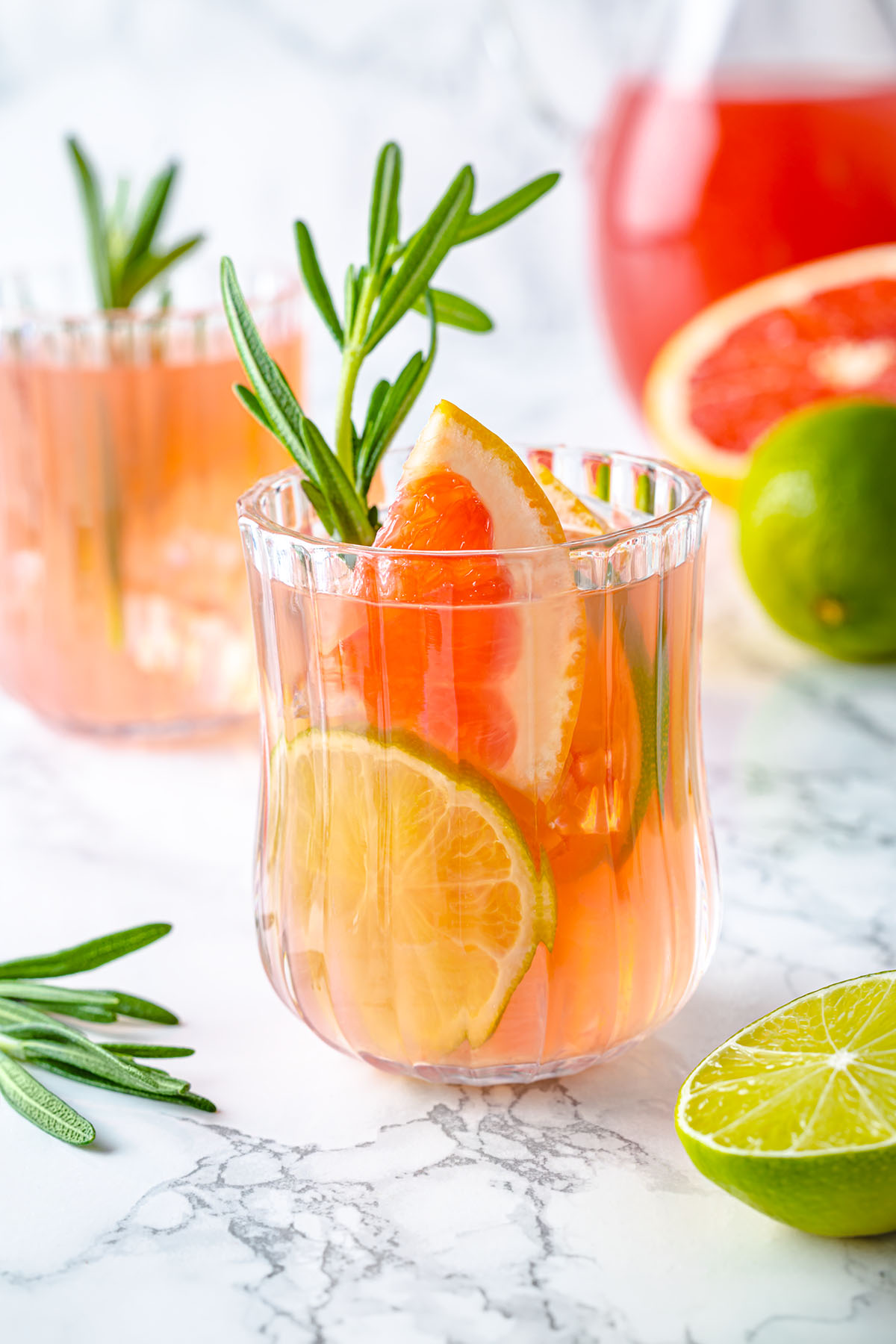 Grapefruit Paloma mocktail in a glass with rosemary sprig