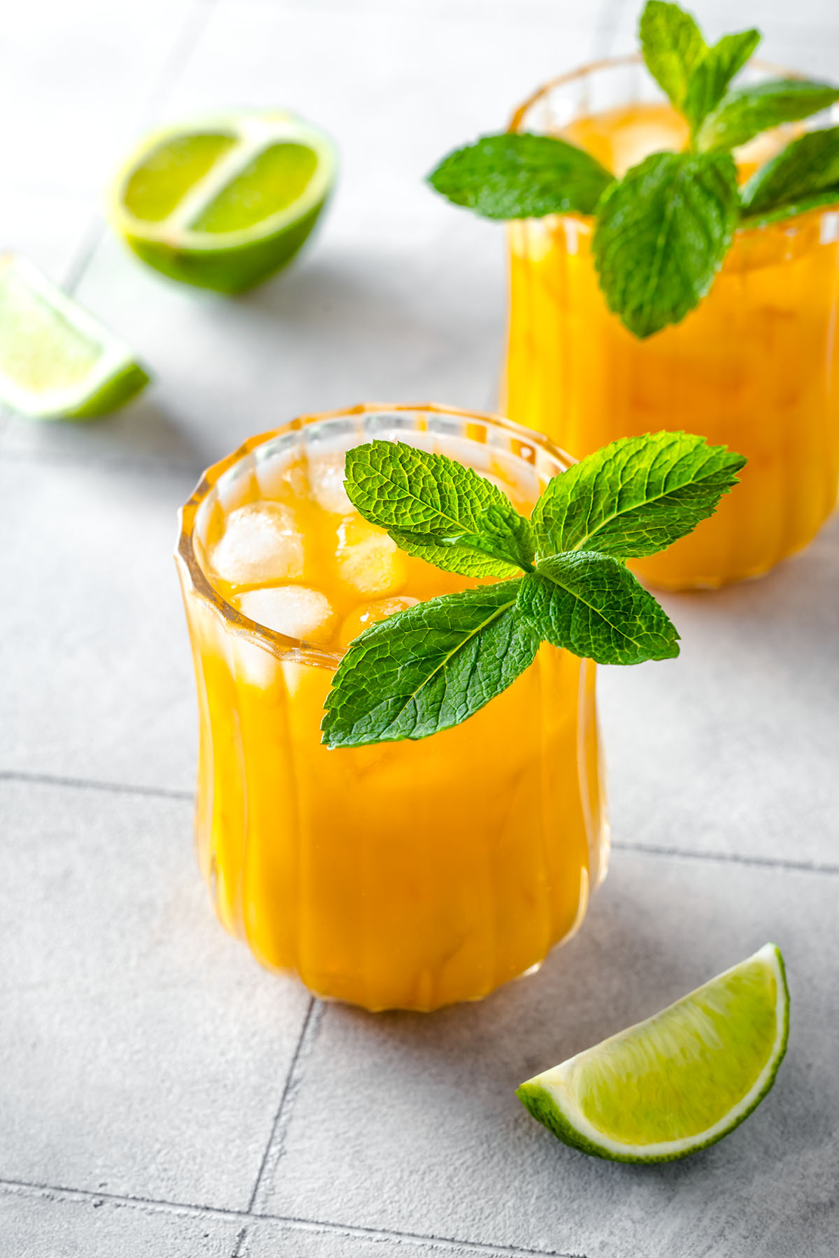 Mango mule mocktail in a glass with fresh mint and wedge of lime