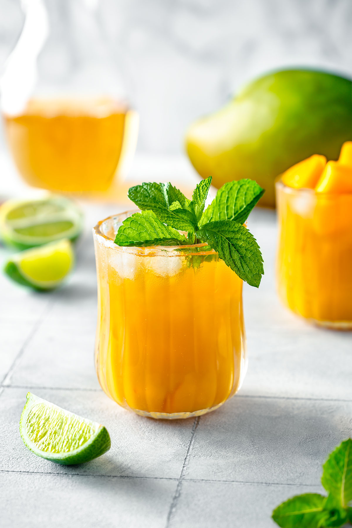 Mango drink in a glass decorated with fresh mint