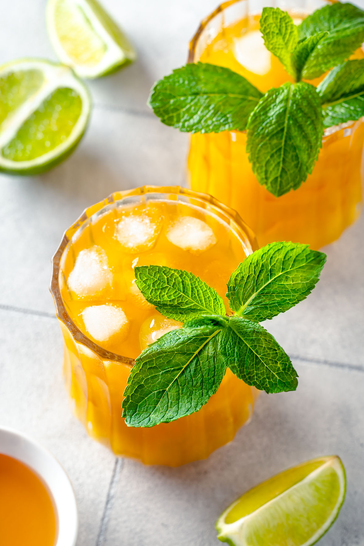 Mango mule mocktail in a glass filled with ice and decorated with fresh mint