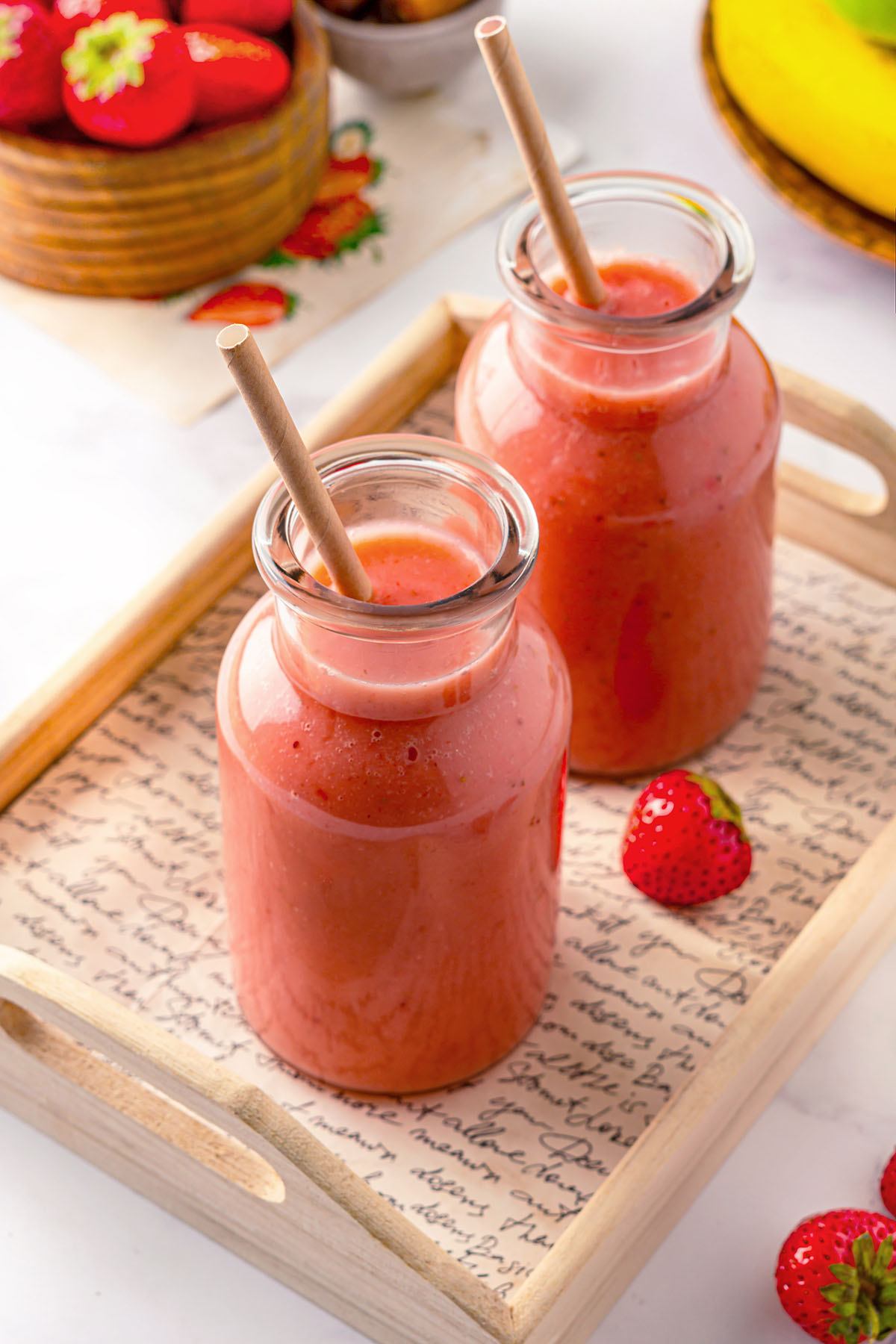 Two bottles with strawberry apple smoothie