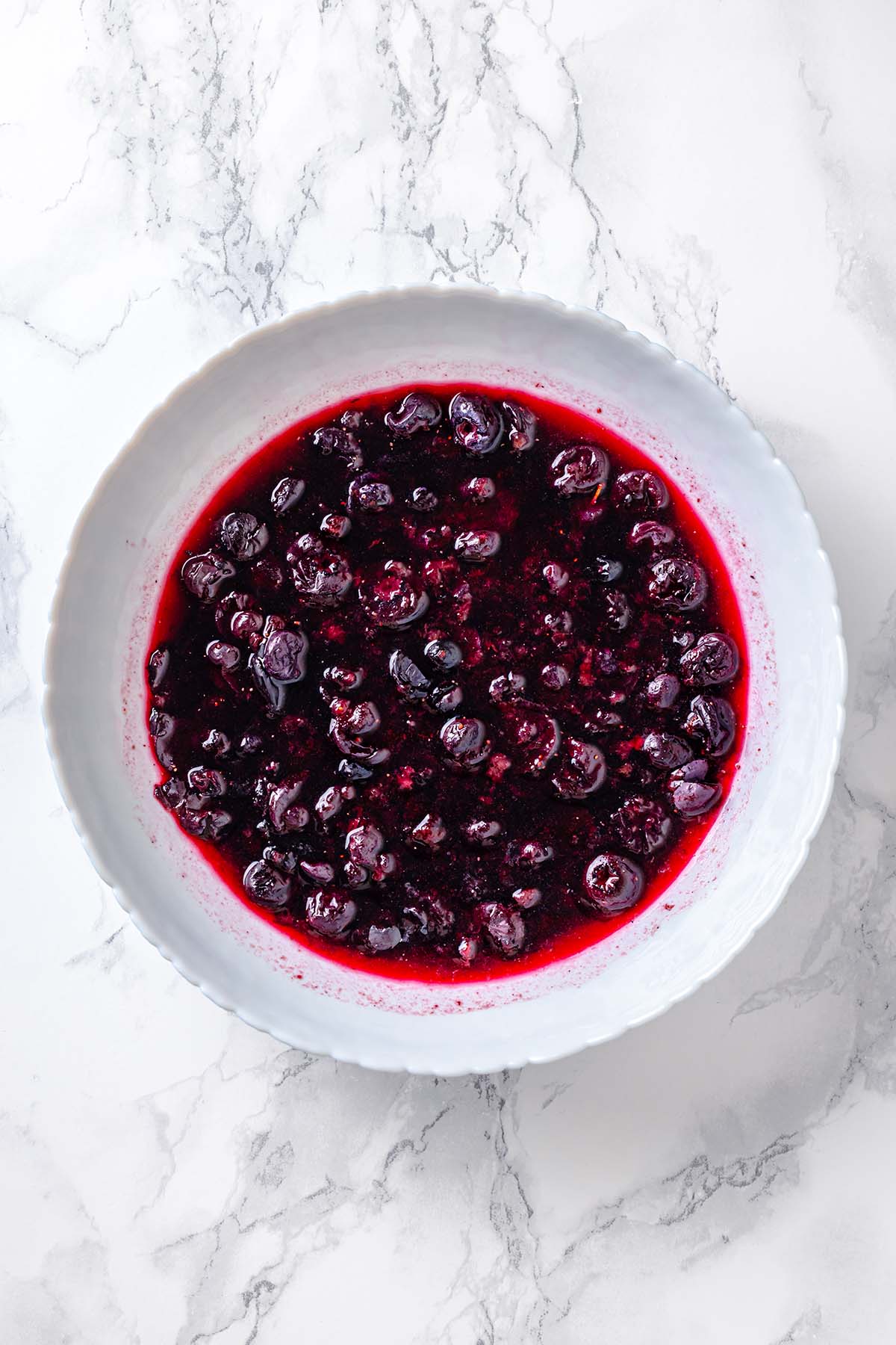 Mashed frozen blueberries in a bowl