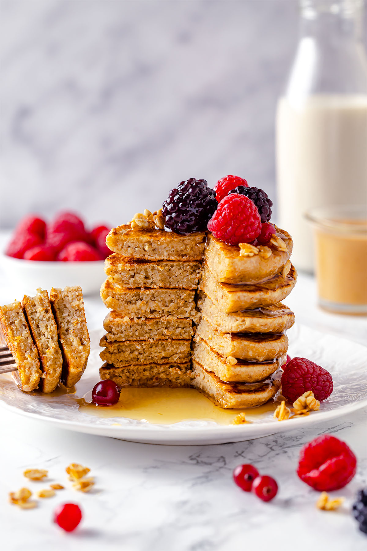 Stack of peanut butter oatmeal pancakes cut to show texture