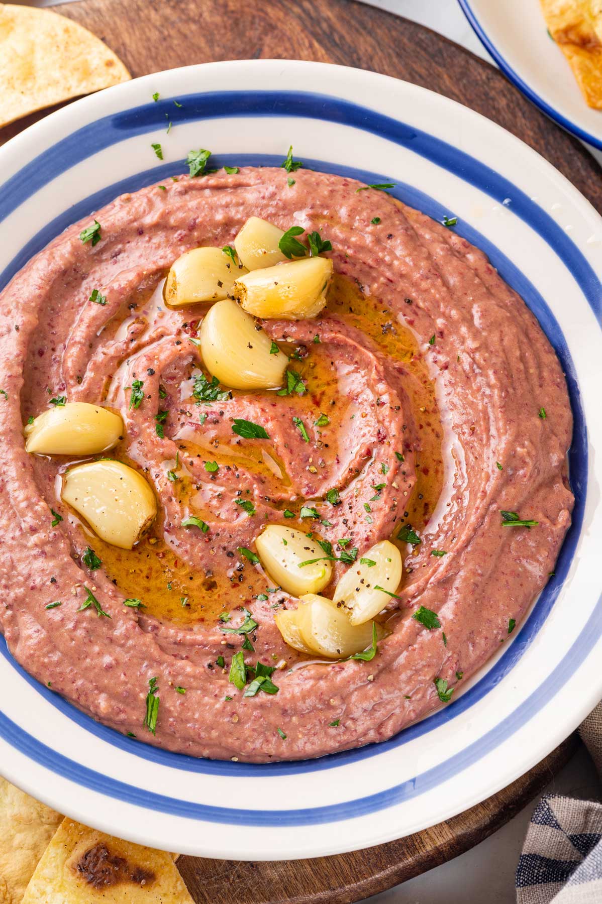 Red kidney bean hummus with roasted garlic in a serving bowl
