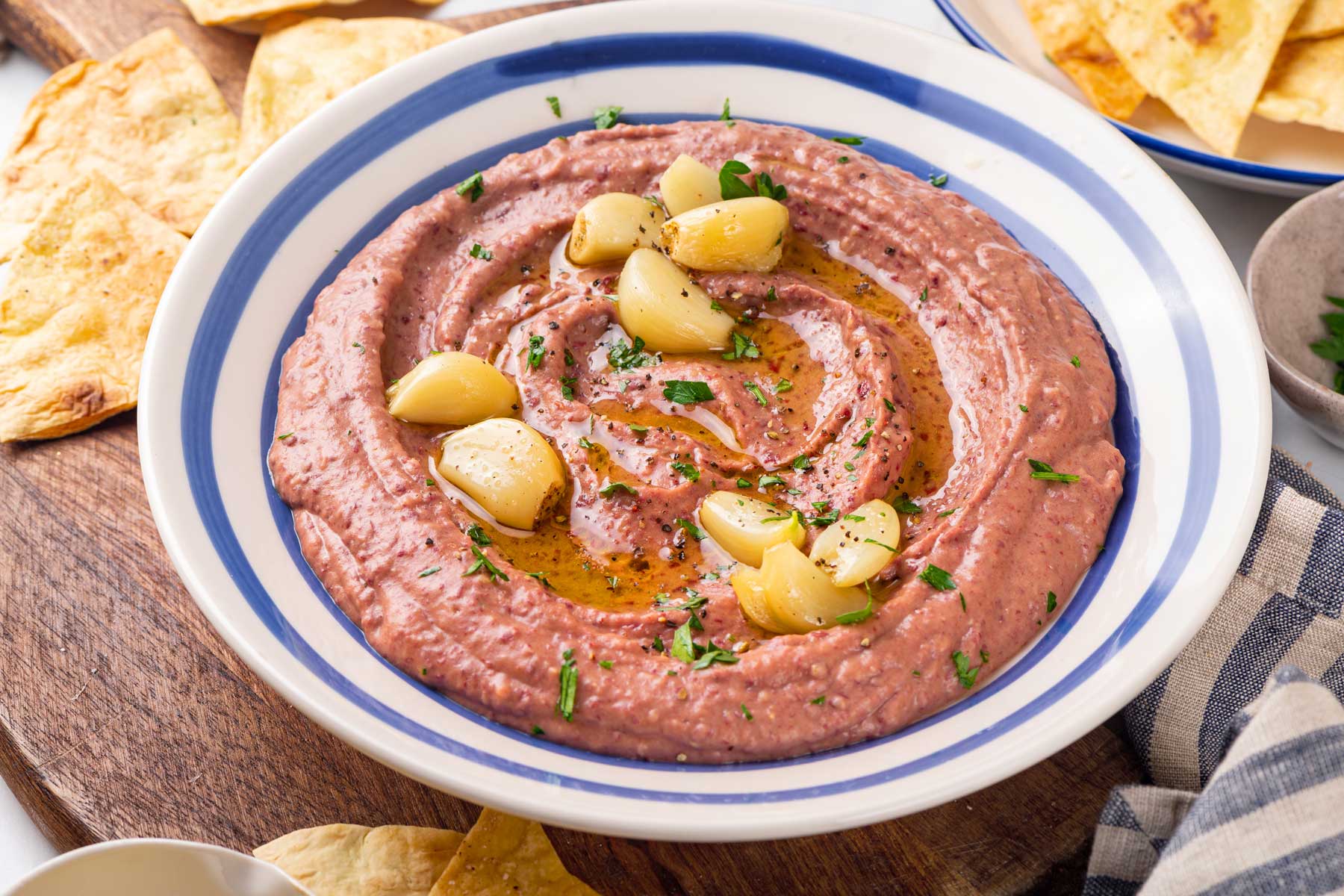 Bowl of red bean hummus with roasted garlic