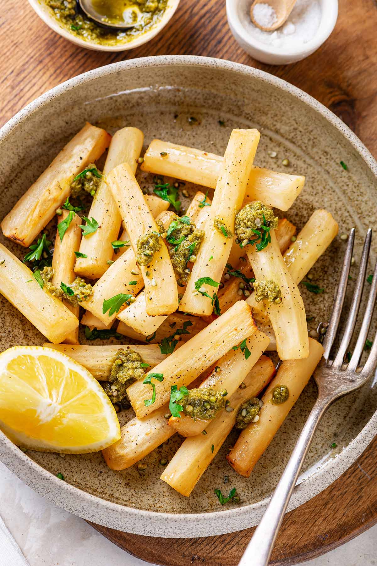 Roasted black salsify served with pesto and fresh parsley