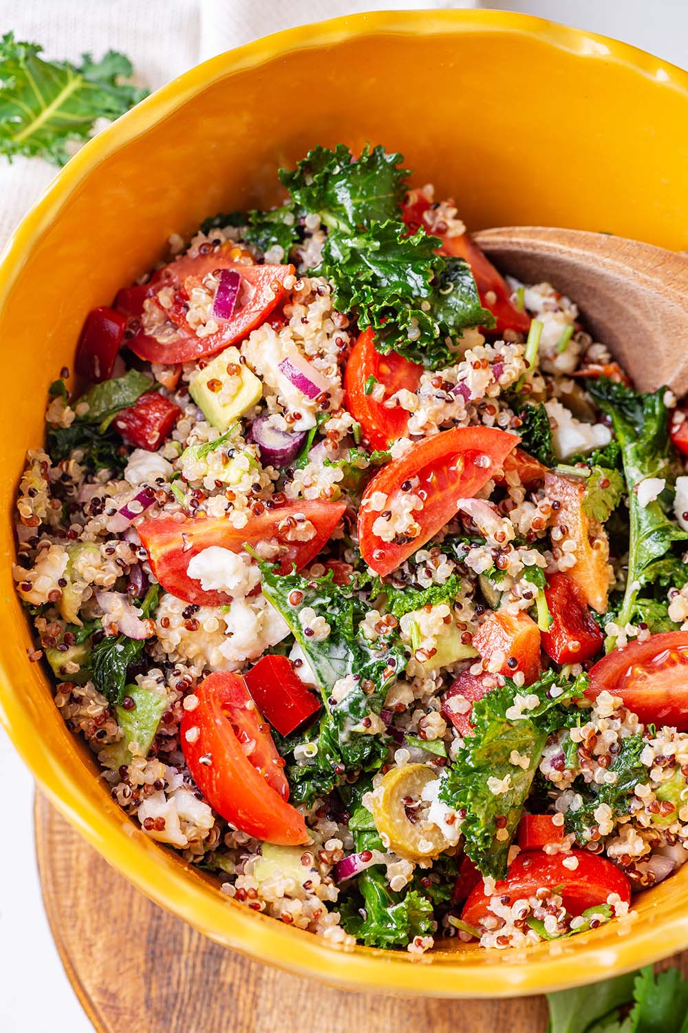 Photo of Mediterranean Quinoa Salad with kale and tahini dressing in a large bowl