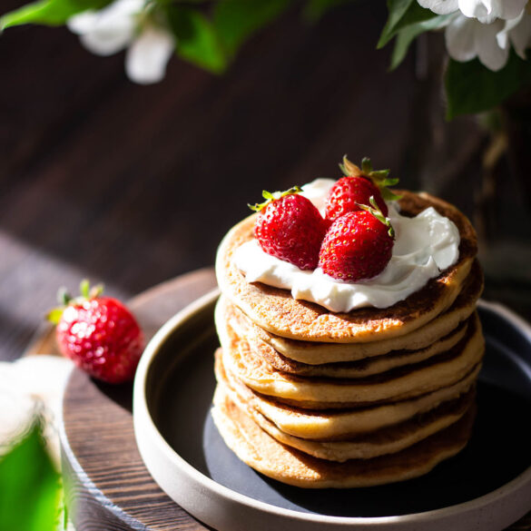 Vegan buttermilk pancakes served with vegan yogurt and strawberries