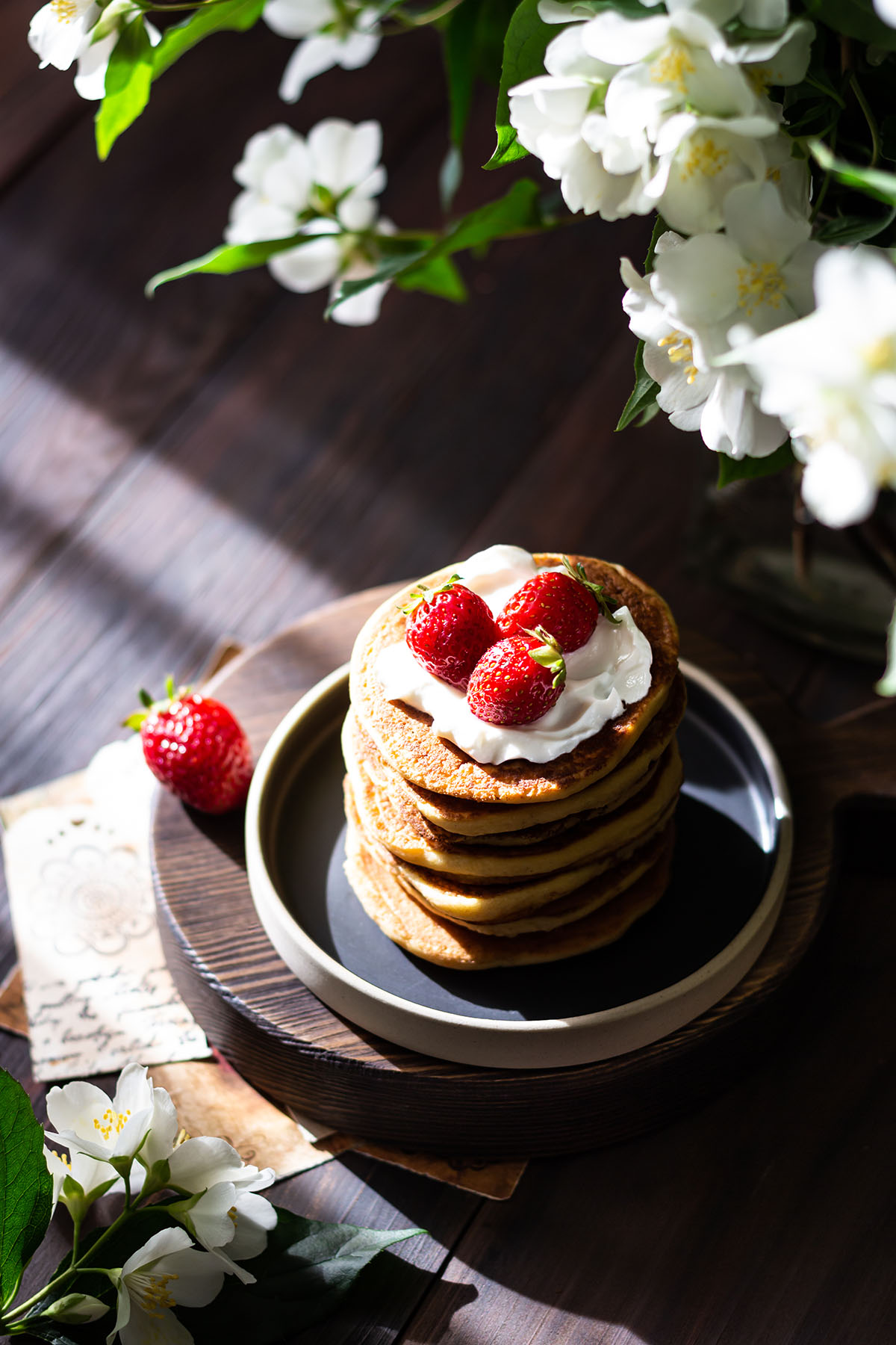 Stack of vegan buttermilk pancakes on a dark wooden table