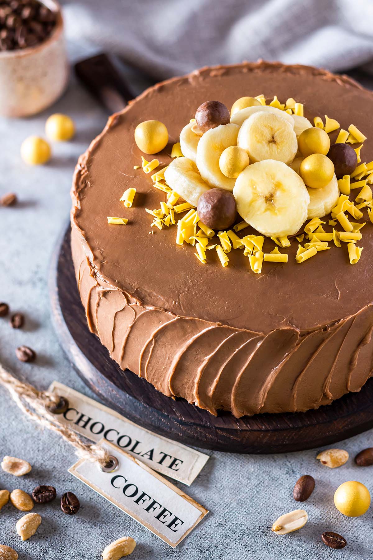 Banana cake with coffee frosting, decorated with bananas