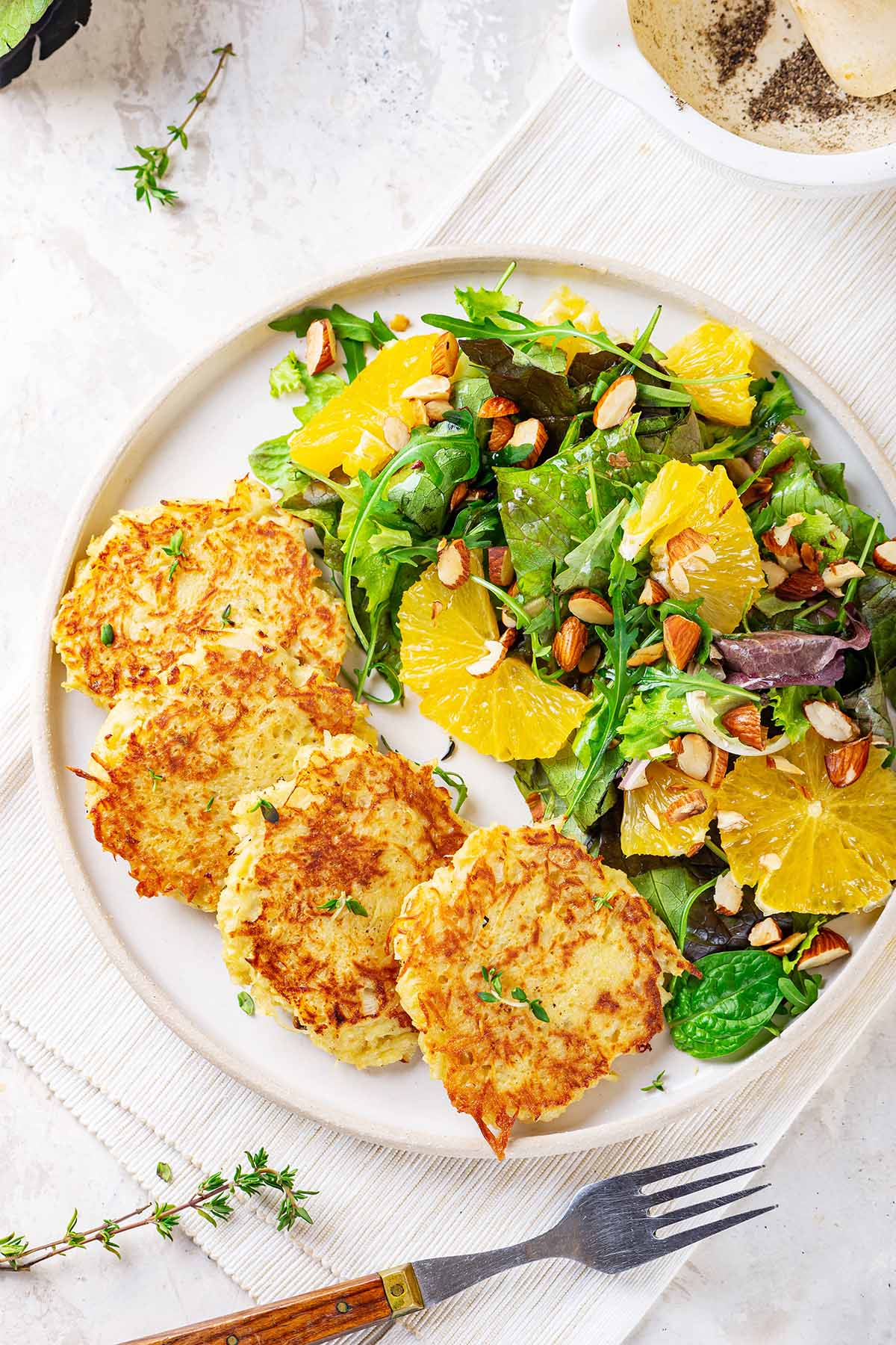A plate with black salsify fritters on a table