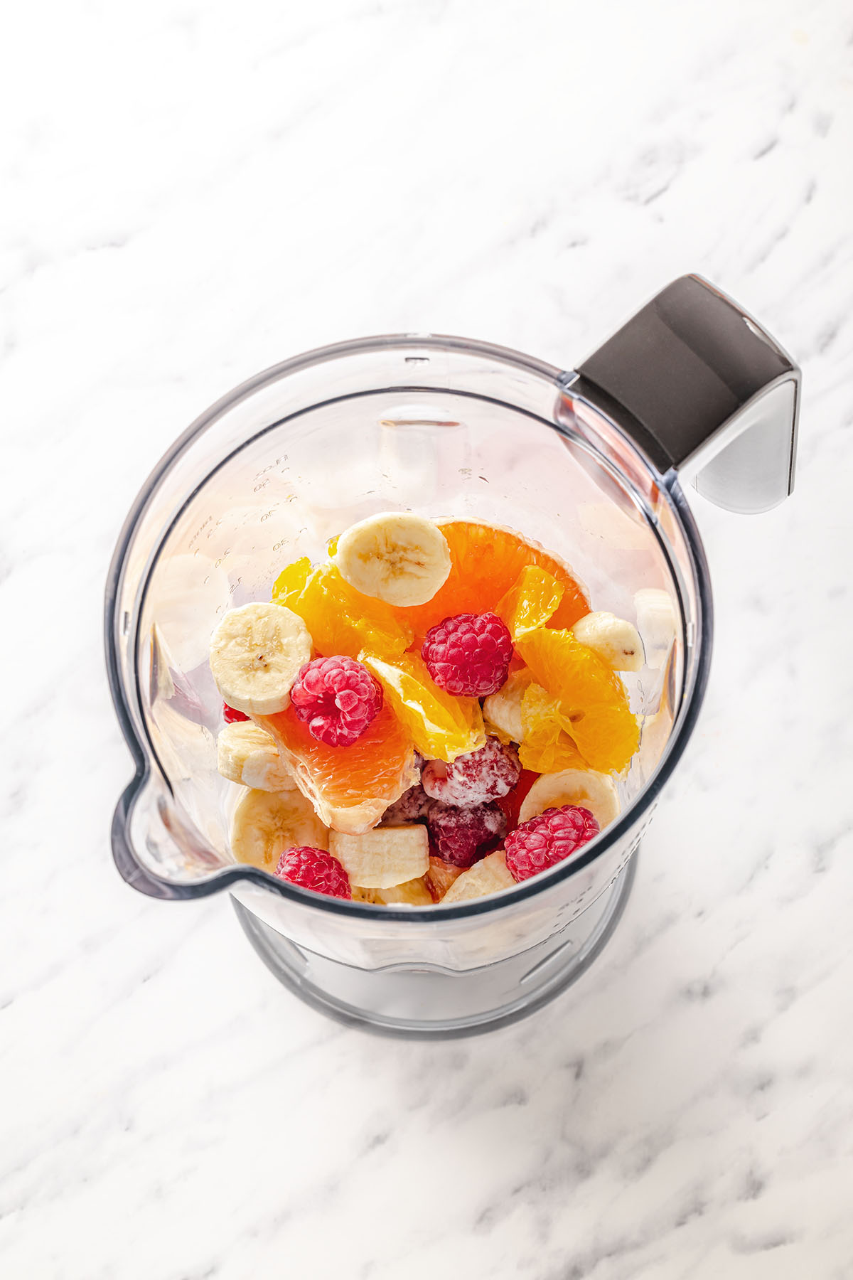 Ingredients for raspberry smoothie in a blender