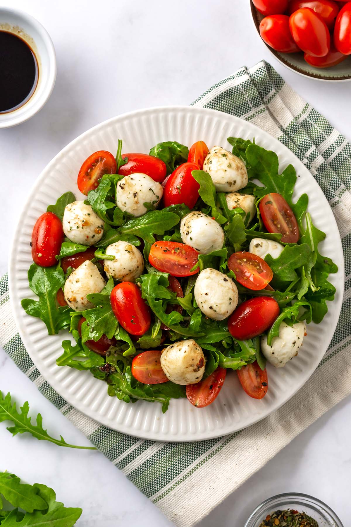 Arugula Caprese Salad on a white serving plate