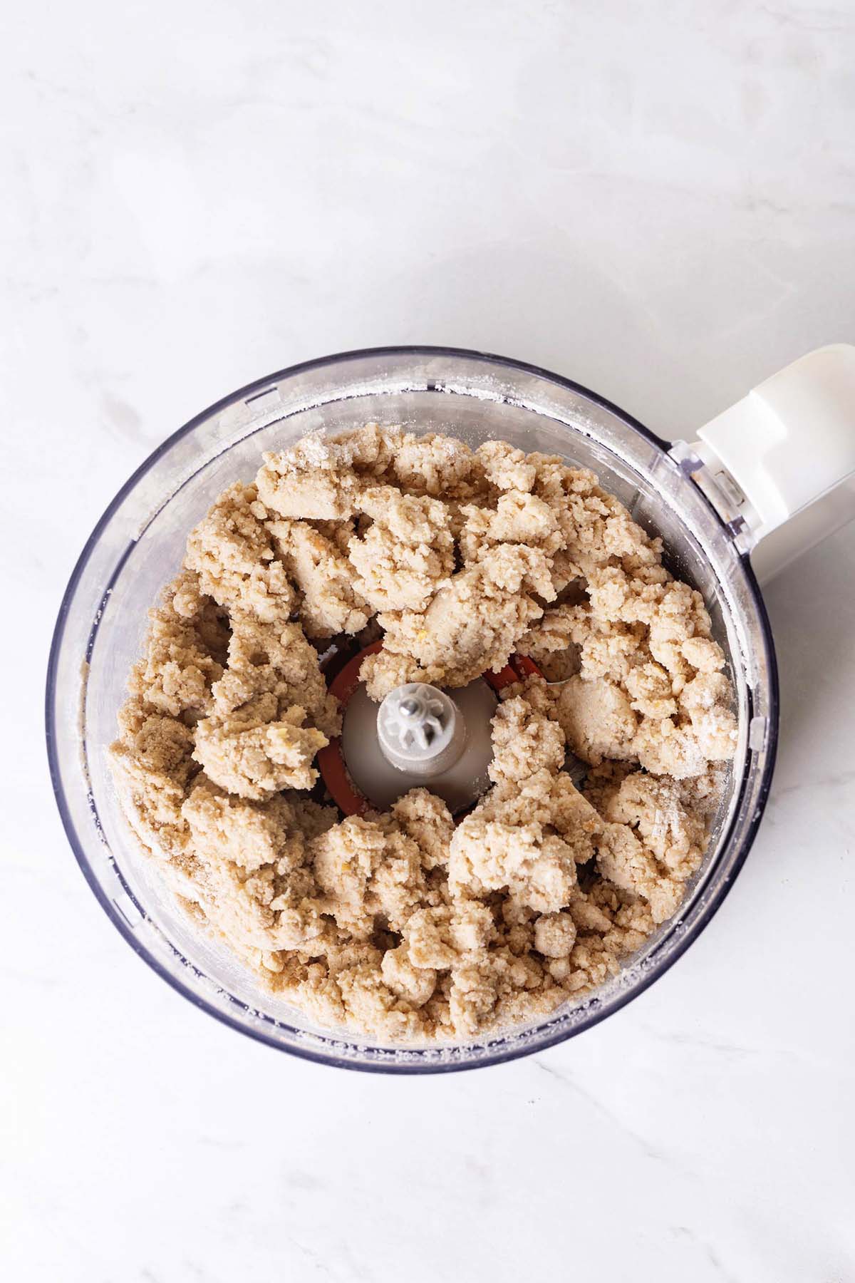 Finished pie crust dough in a food processor