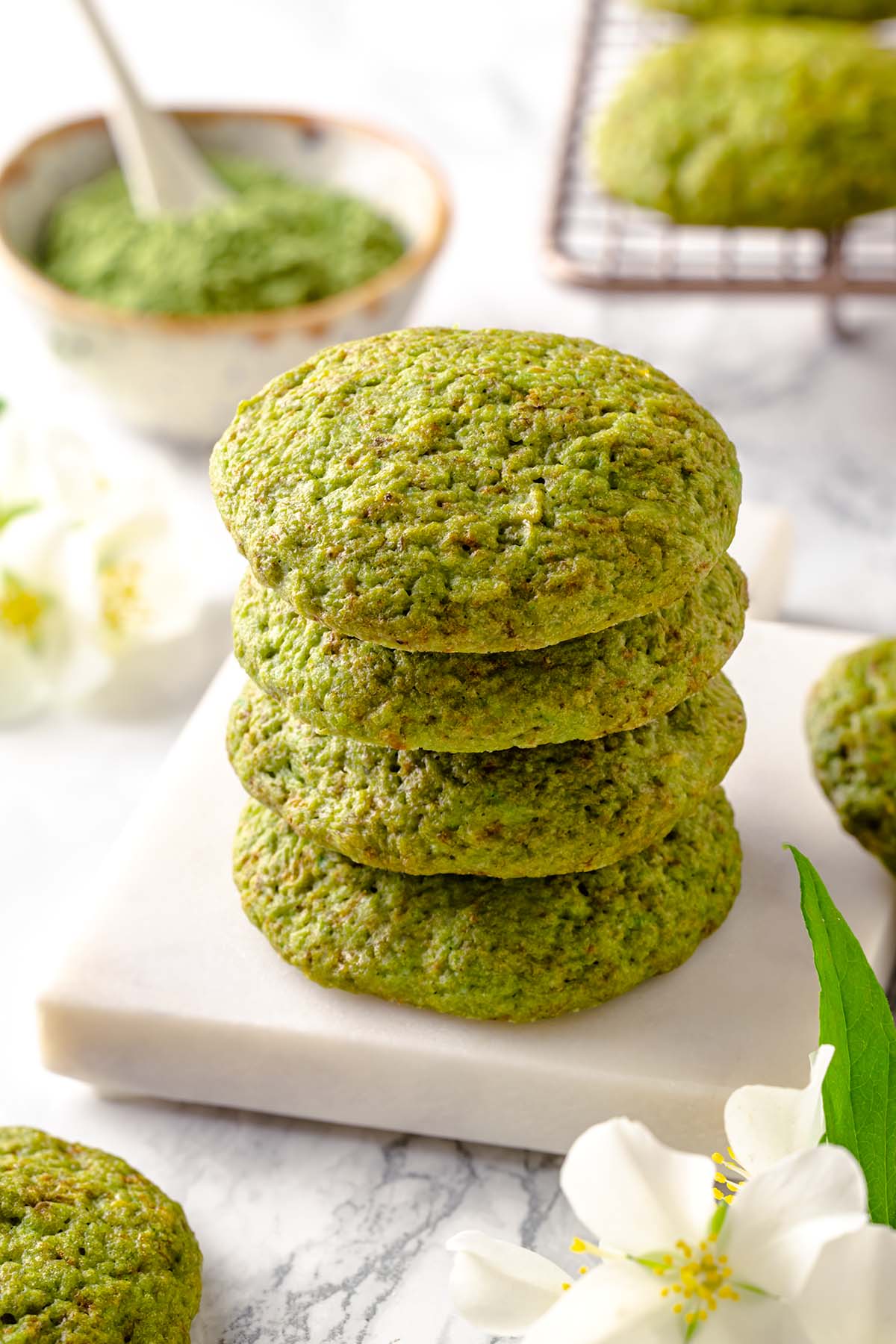 Stack of green moringa cookies on a white board