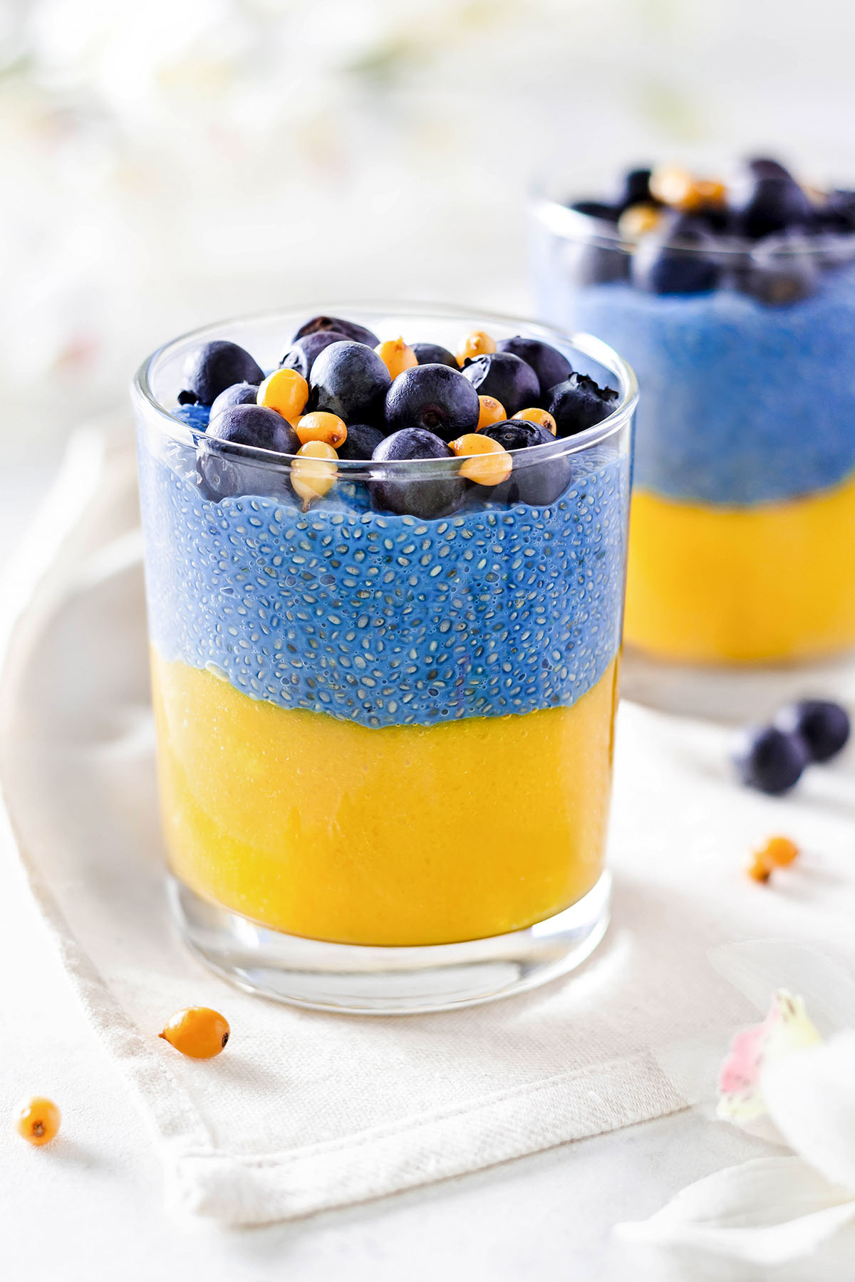 Mango chia pudding  of blue and yellow layers in a glass