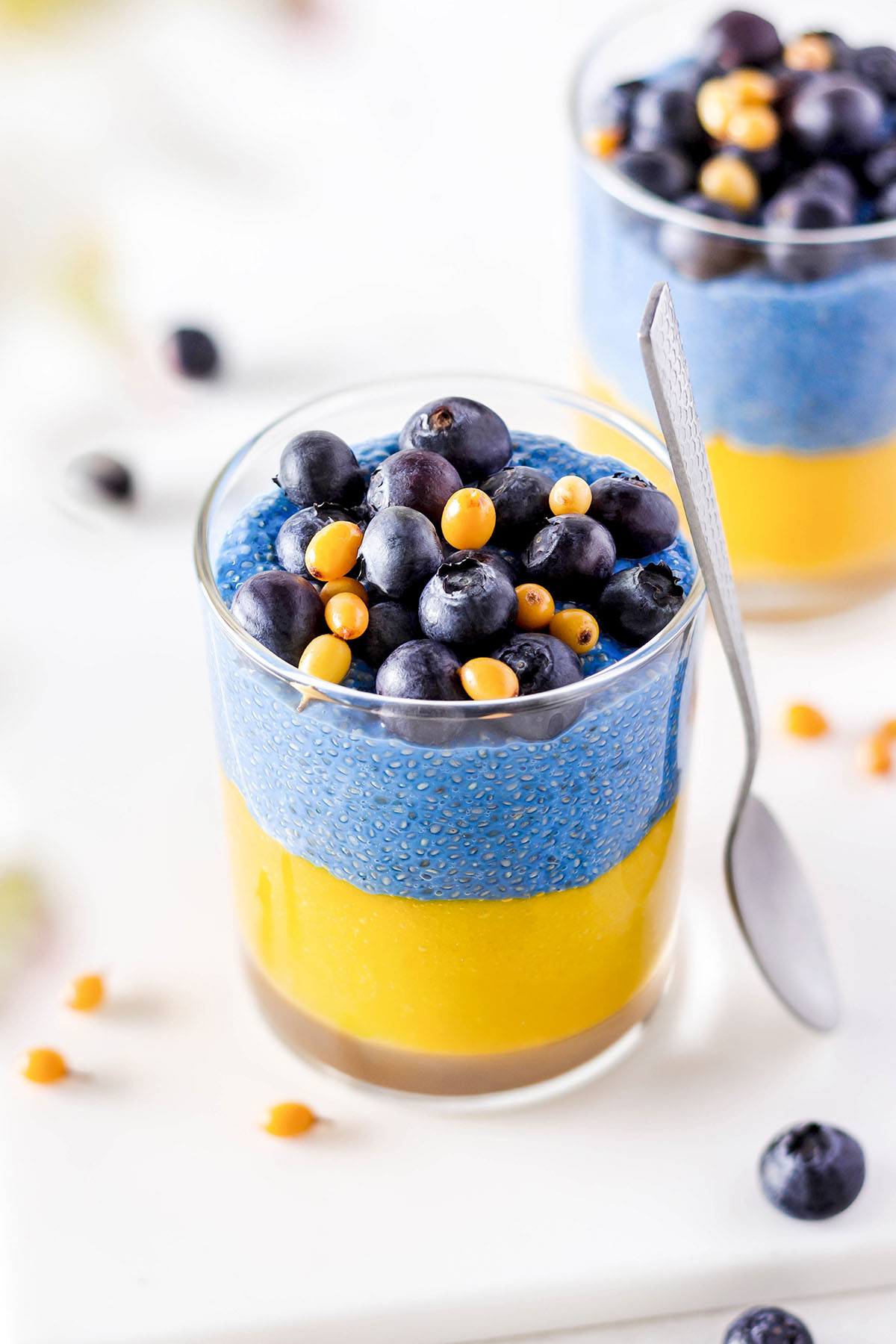 Blue chia pudding with mango in a glass