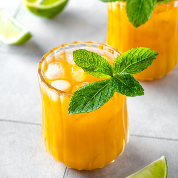 Mango mule mocktail in a glass with fresh mint and wedge of lime