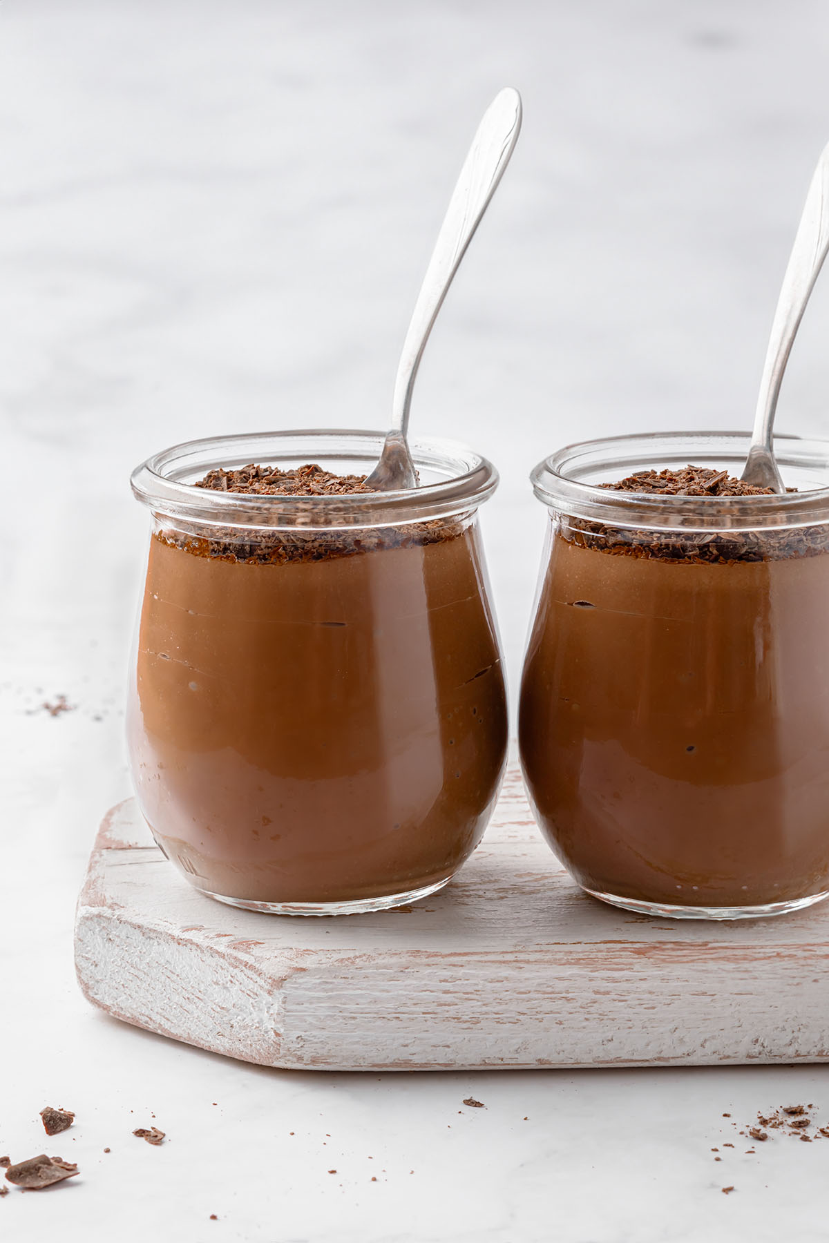 Two serving jars filled with creamy silken tofu chocolate pudding