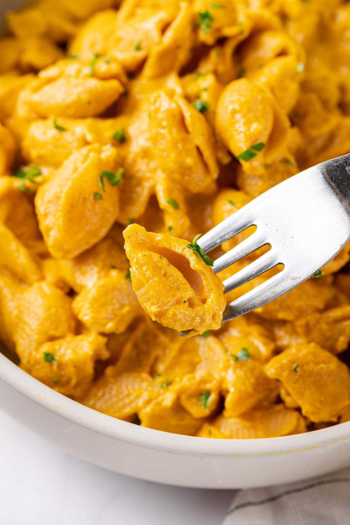 Fork with carrot vegan mac and cheese