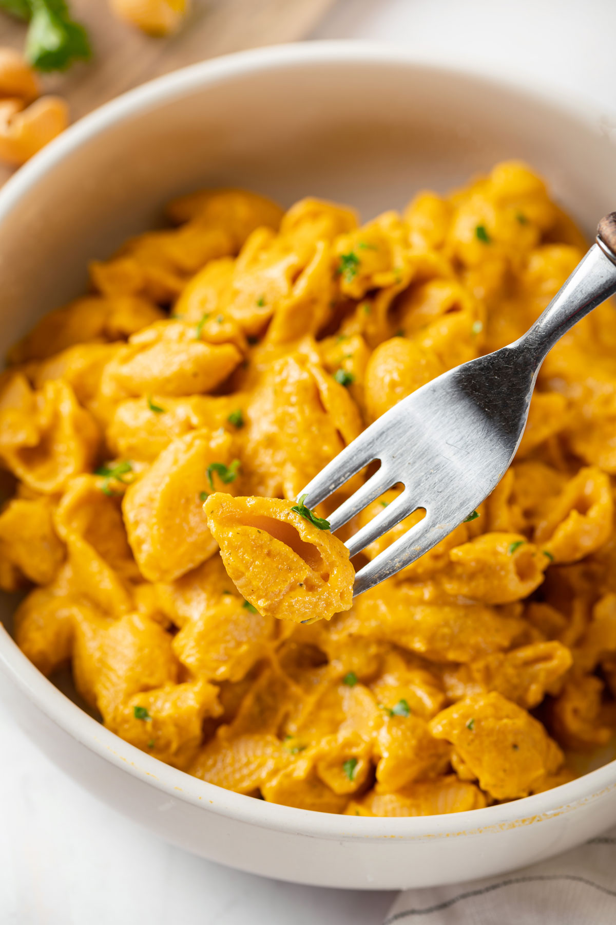 Fork with carrot vegan mac and cheese